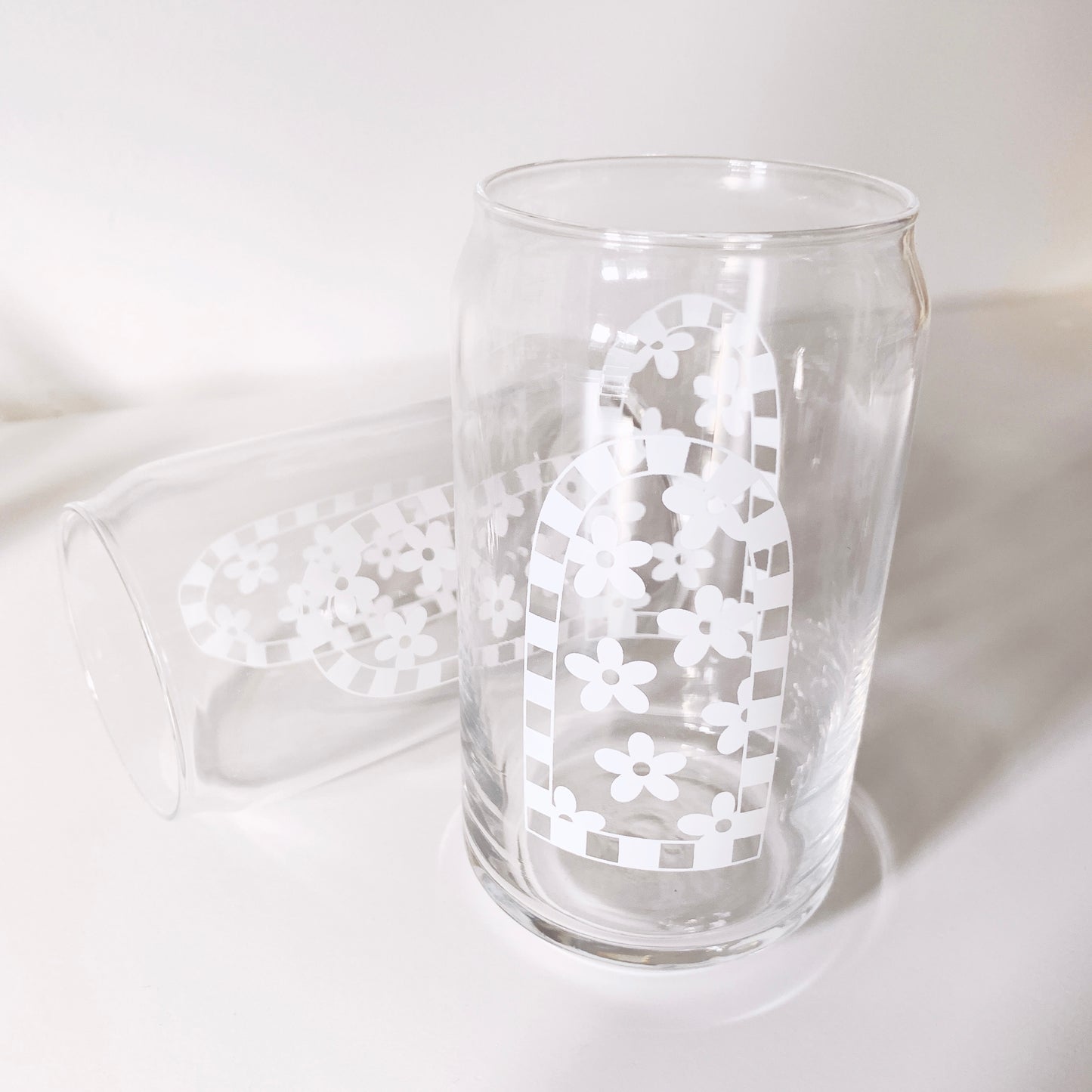 Detail shot of daisy arch can glass highlighting floral pattern