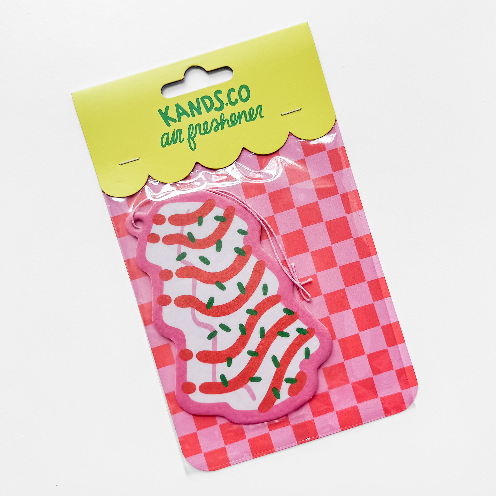 Packaged Christmas tree cake air freshener showing product in clear packaging