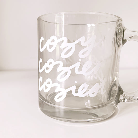 Clear glass mug with 'Cozy Cozier Coziest' comfort text