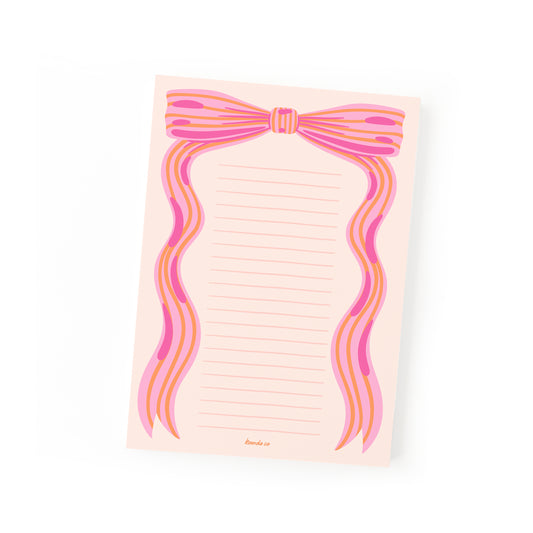 Pink notepad with little bow design and feminine aesthetic