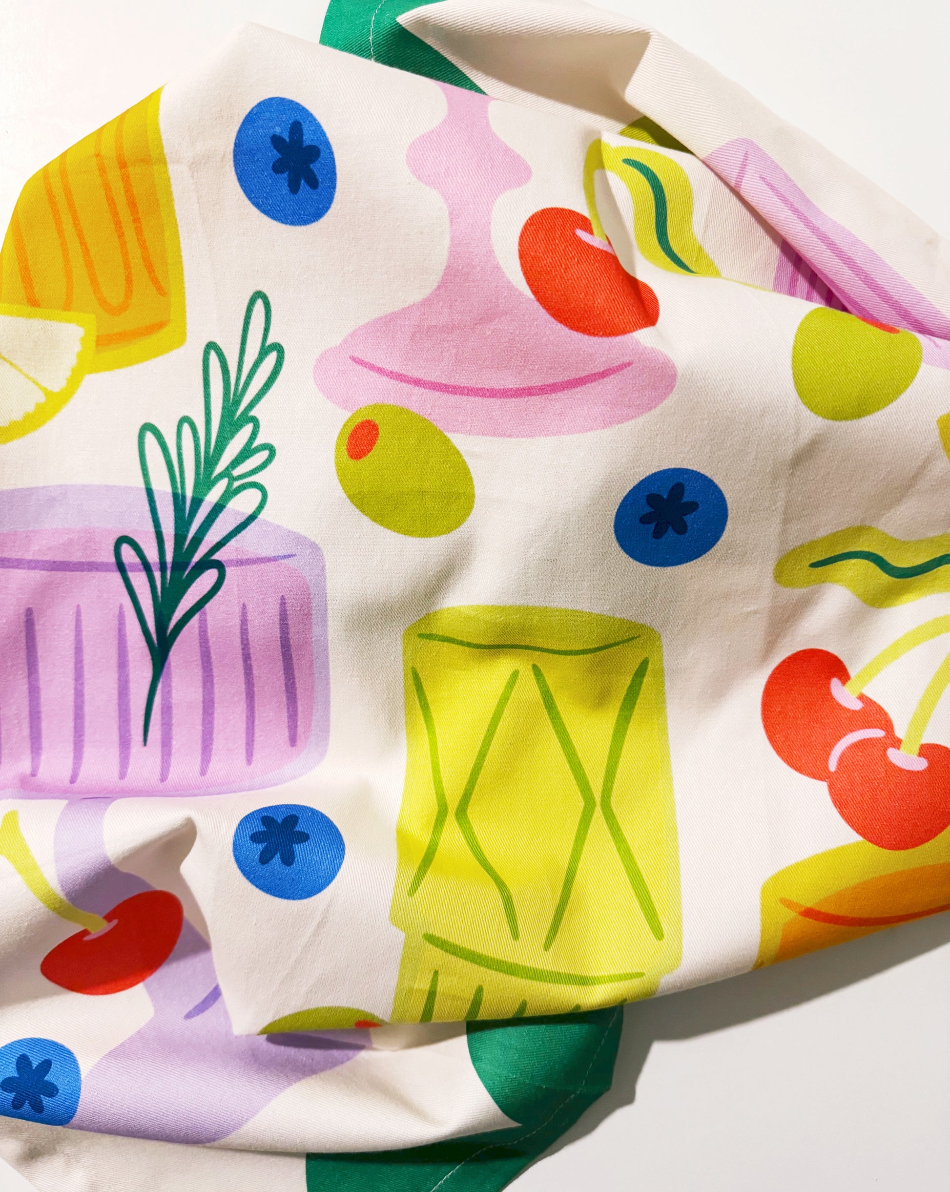 Close-up of vintage cocktails tea towel showing drink illustrations