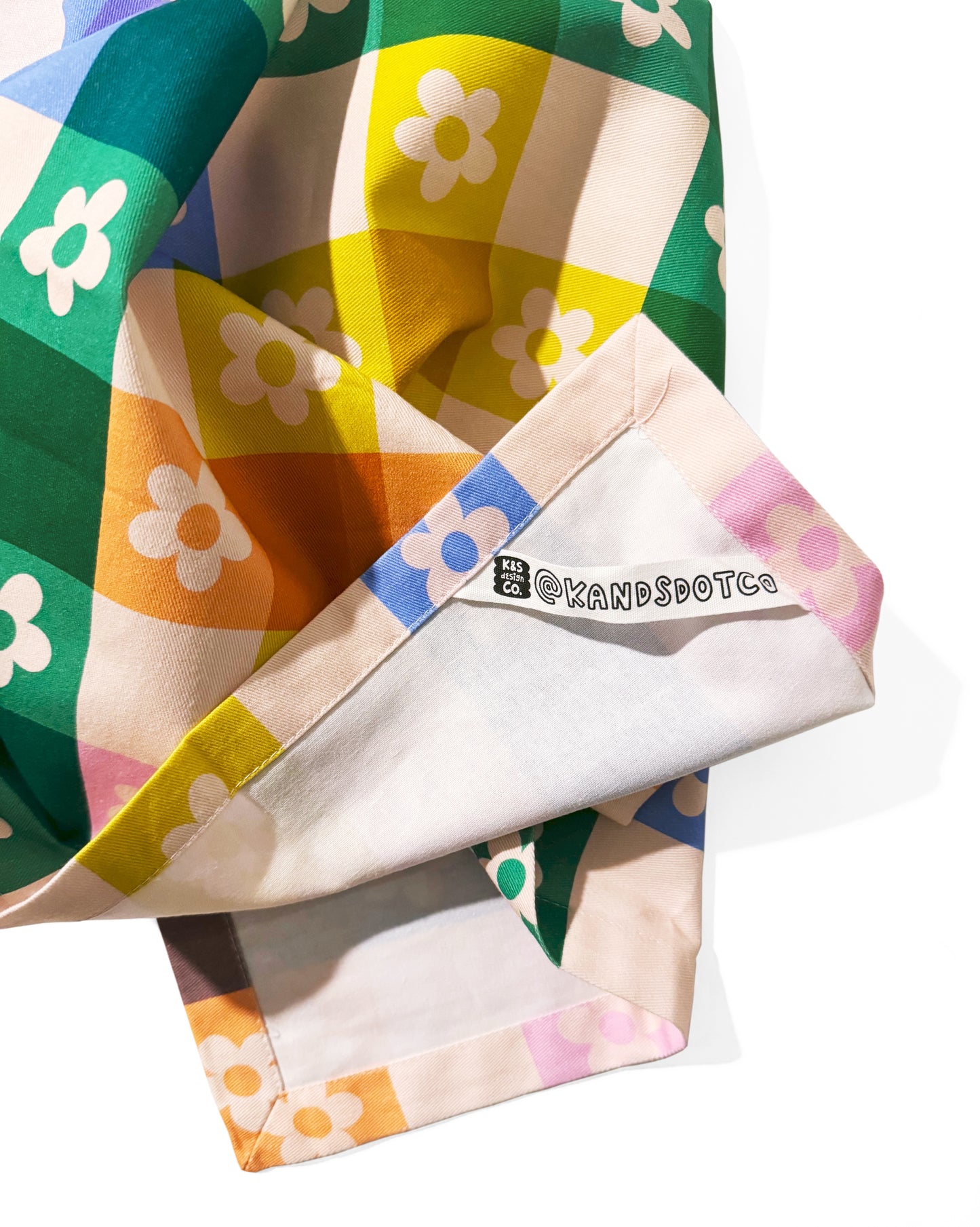 Close-up of daisy plaid tea towel showing botanical plaid pattern