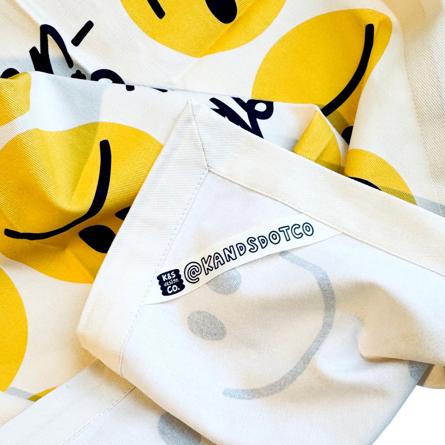 Happy eating tea towel hanging on kitchen hook showing functionality