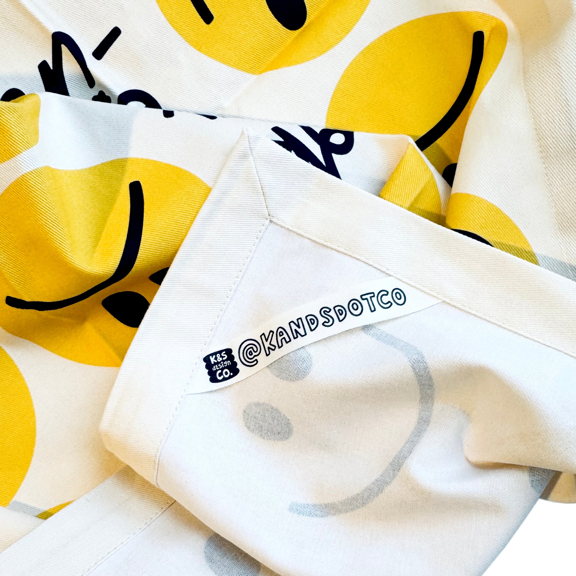 Happy eating tea towel hanging on kitchen hook showing functionality