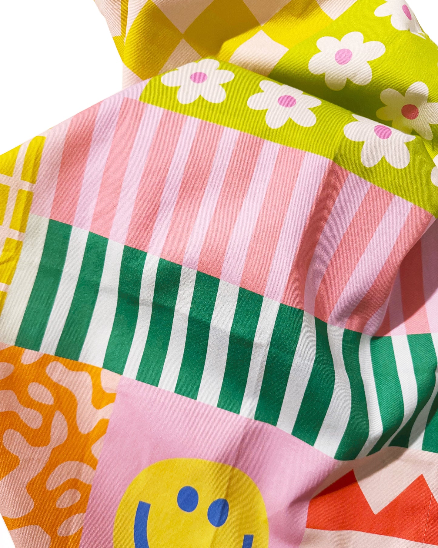 Side view of happy quilt tea towel showing textile pattern