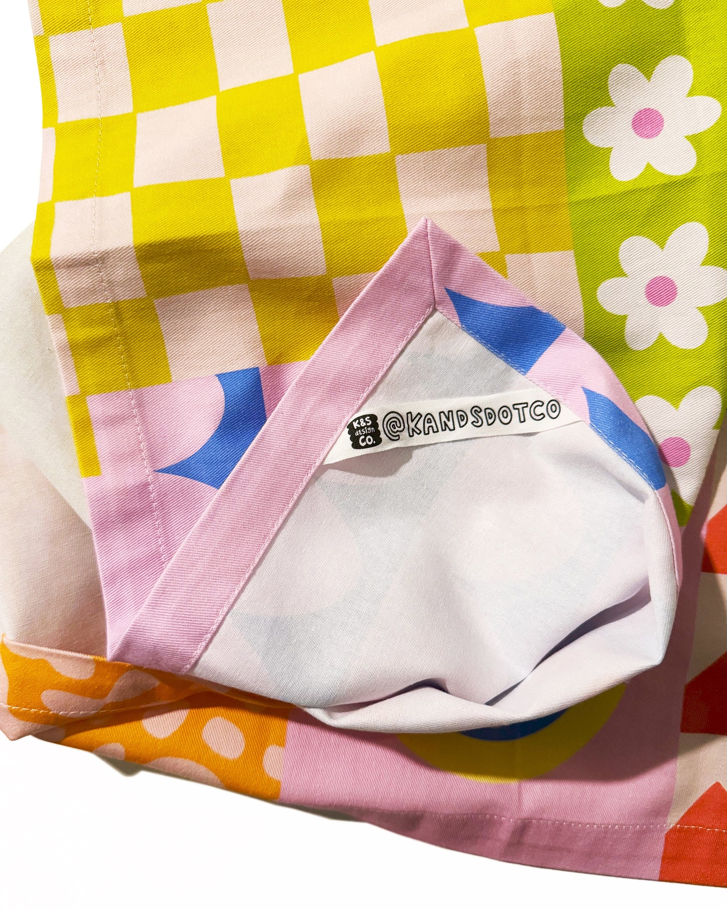 Detail shot of happy quilt tea towel highlighting patchwork design