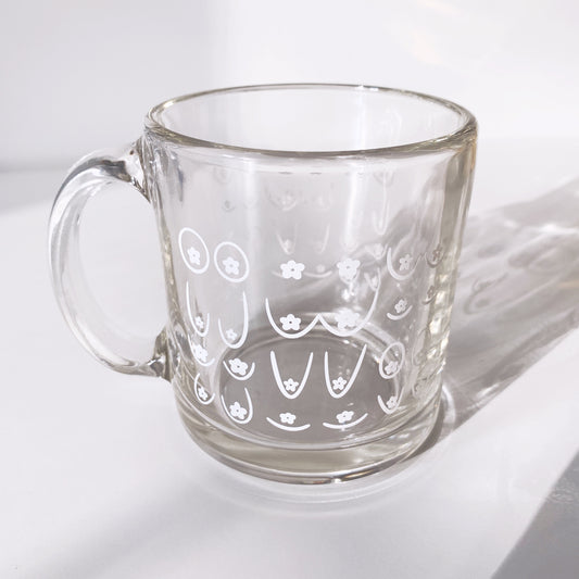 Ceramic mug with daisy boob design and playful floral pattern