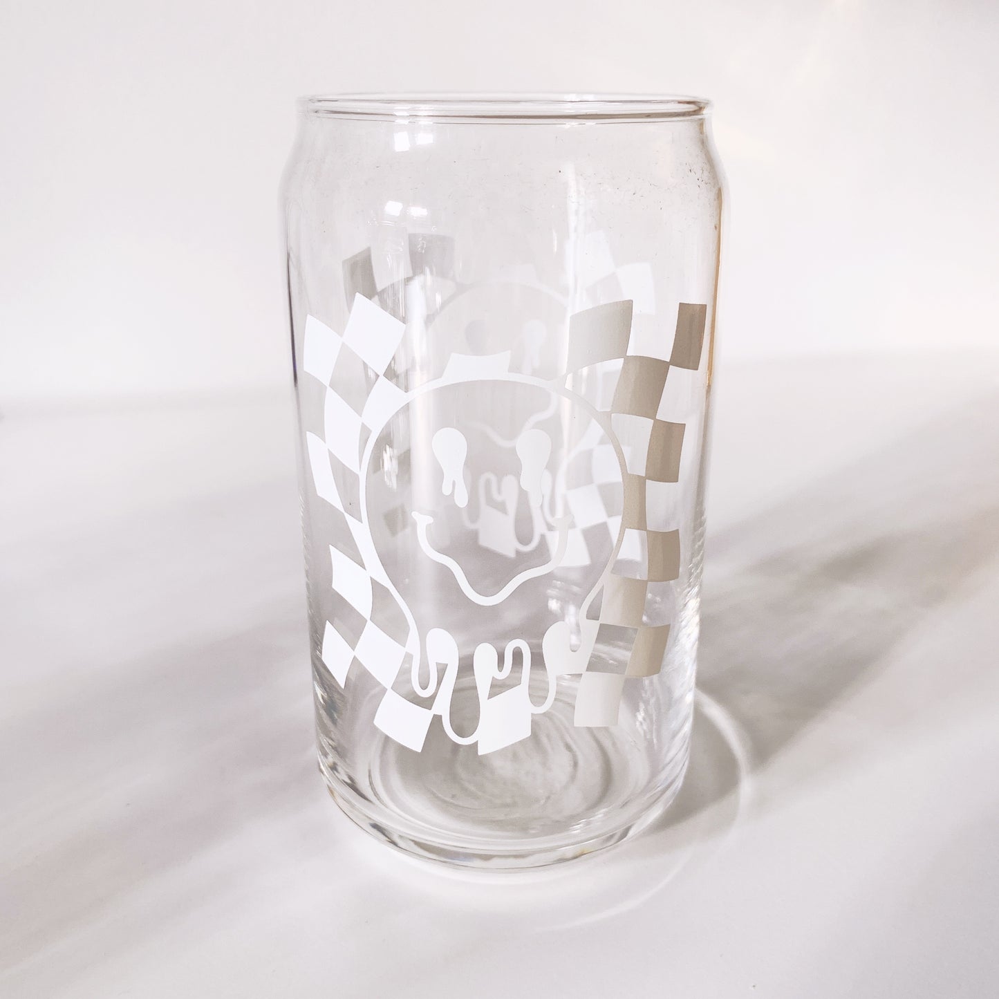 trendy can-shaped glass with drippy smiley face design