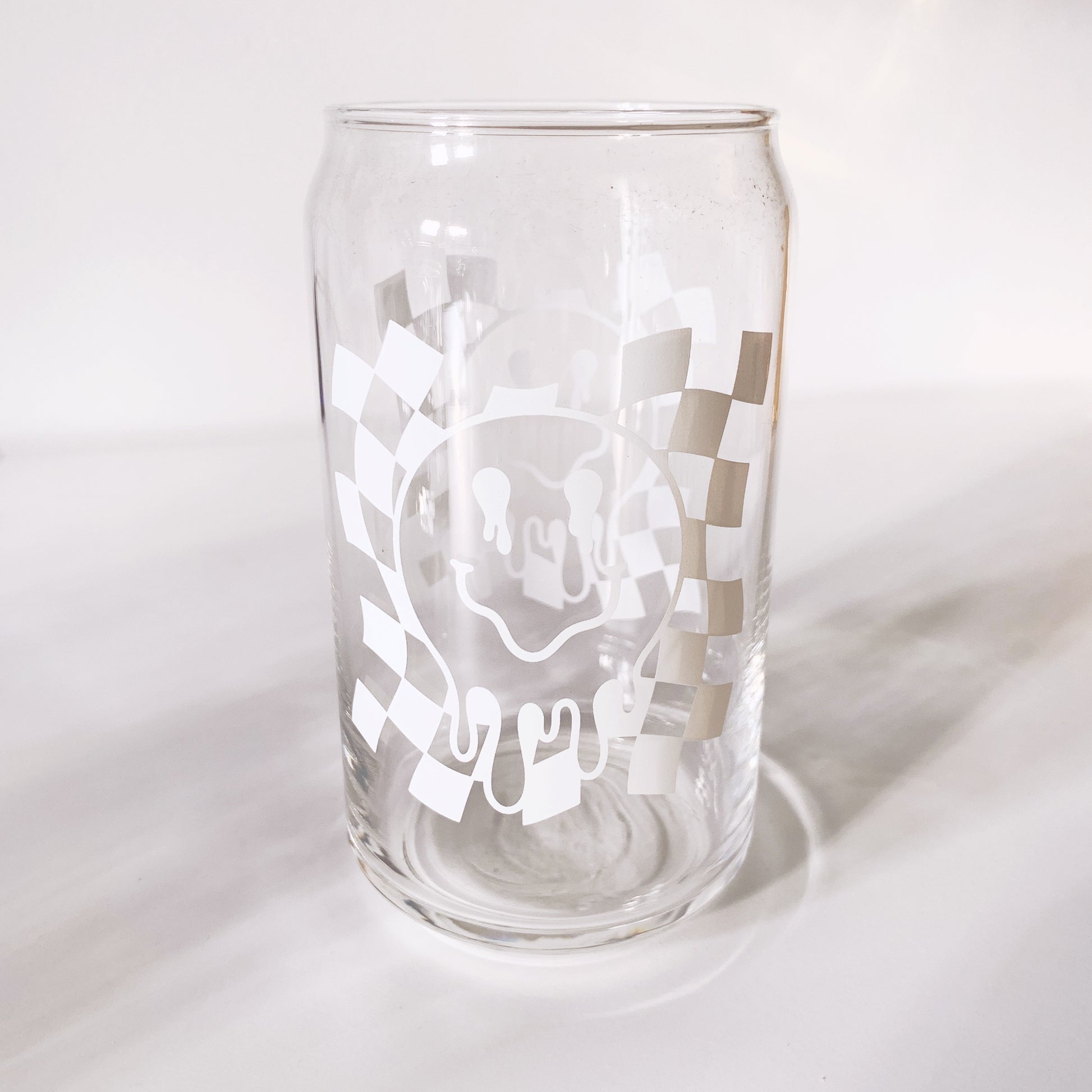 trendy can-shaped glass with drippy smiley face design