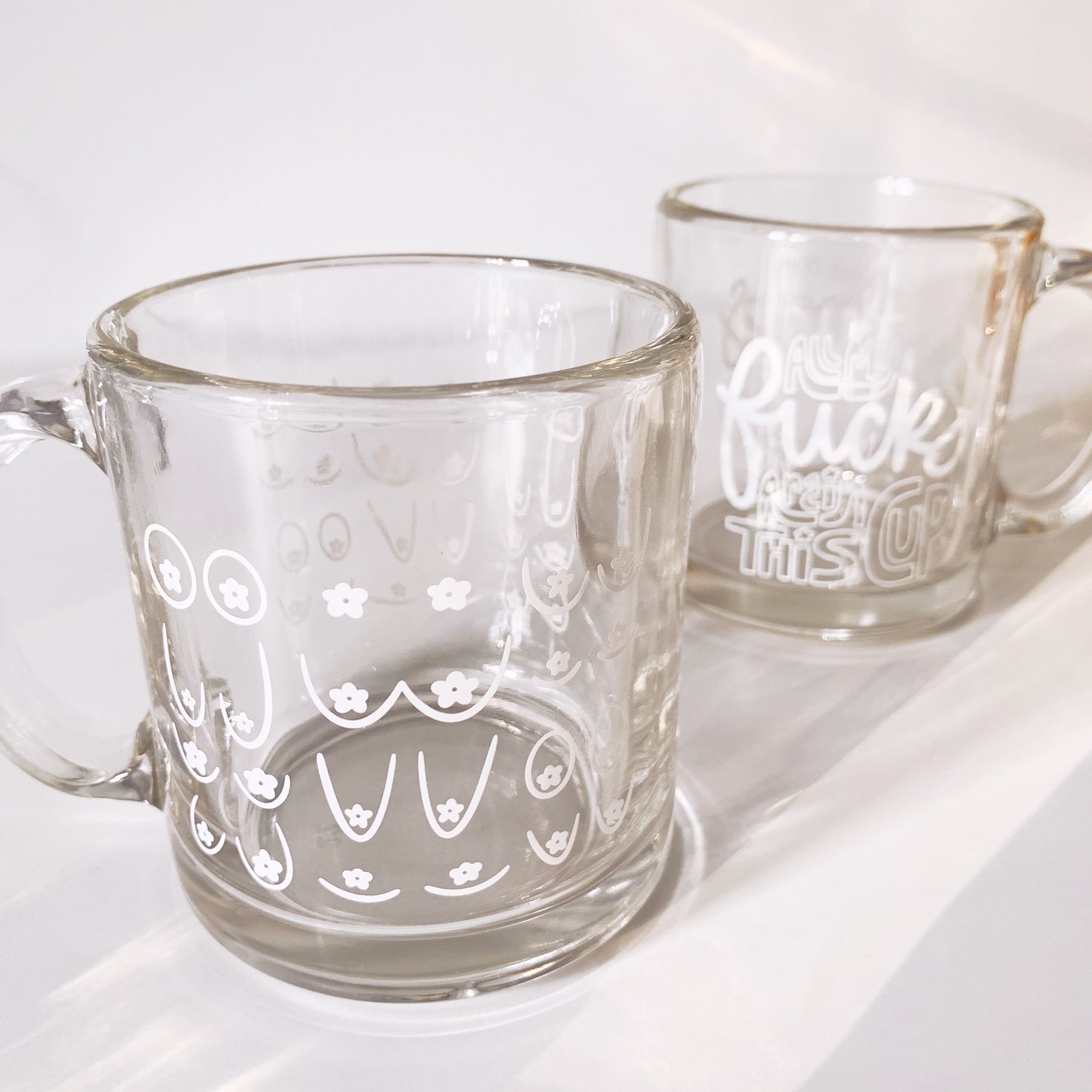 Close-up of daisy boob mug highlighting artistic floral motif