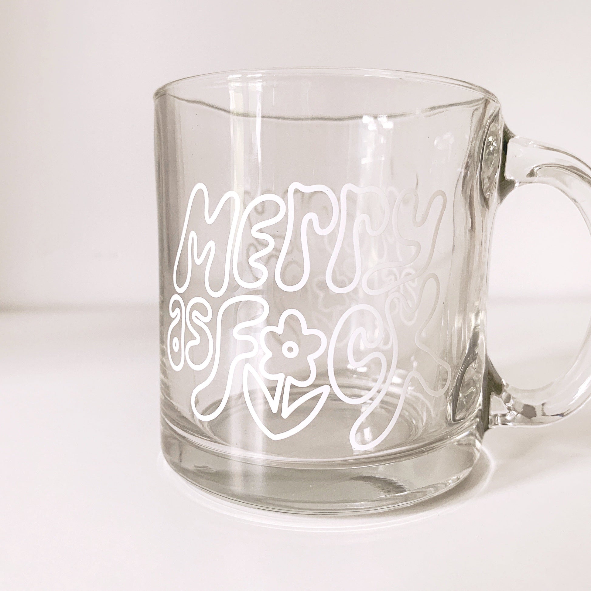 Clear glass mug with 'Merry As Fuck' bold holiday text