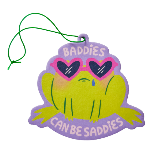 Frog shaped air freshener with 'Baddies Can Be Saddies' text and cute sad expression