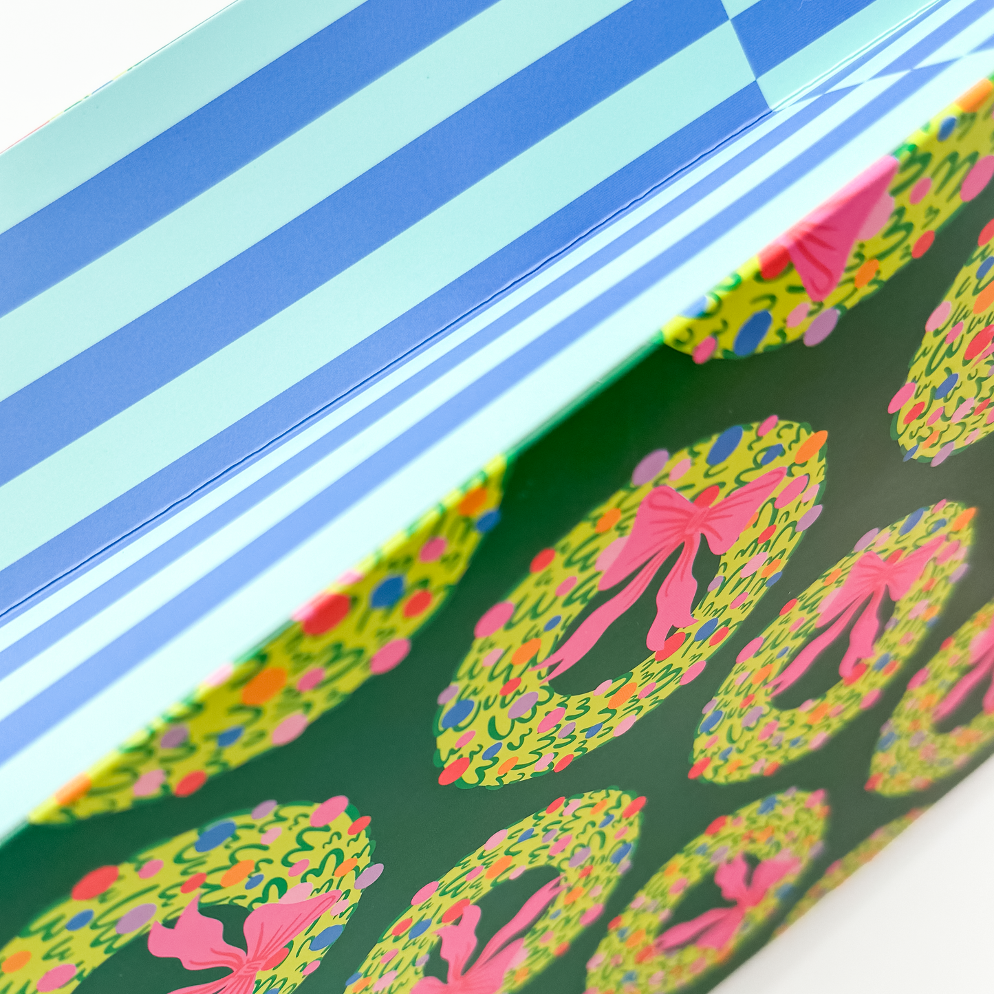 Detail view of rainbow wreath gift bag showing festive circular design