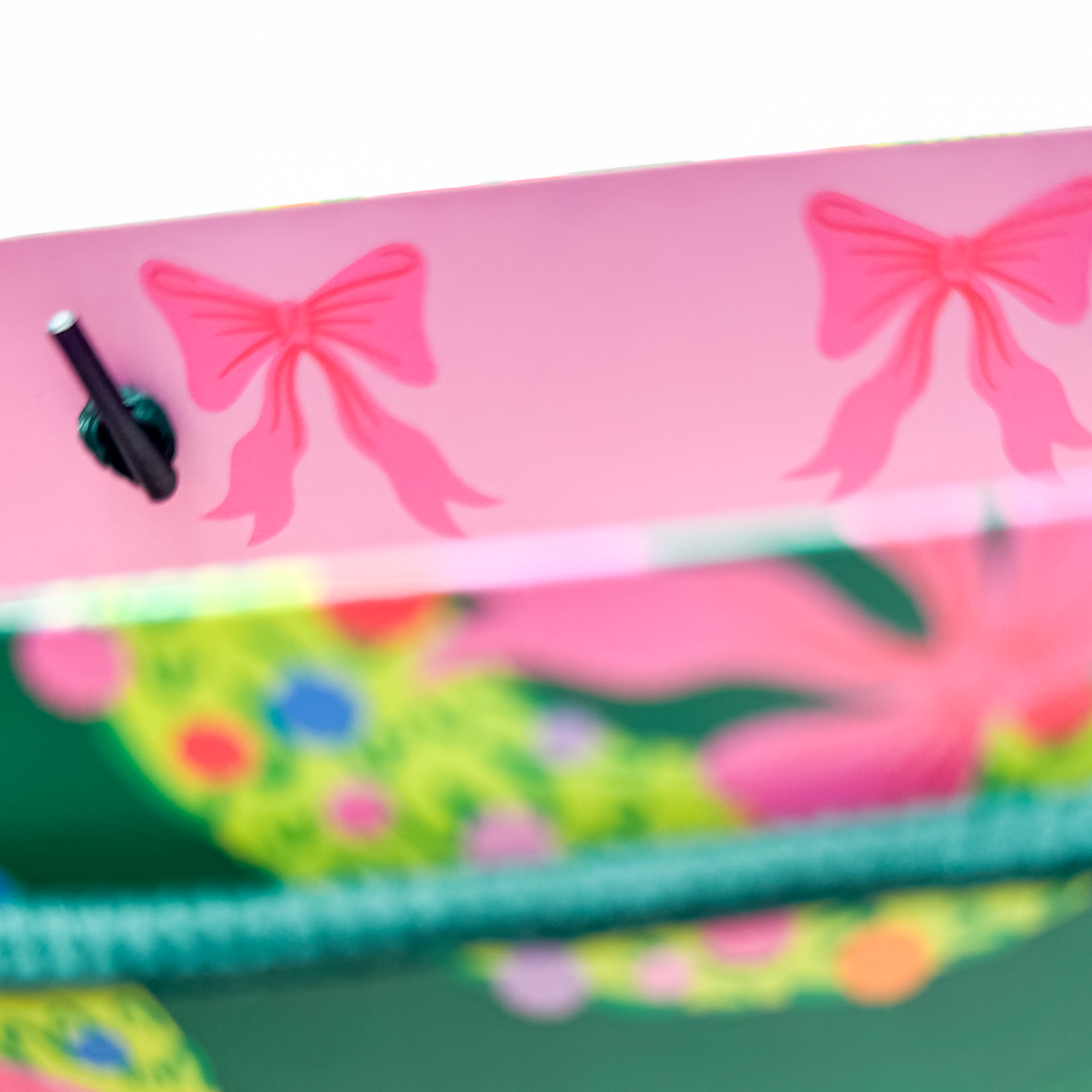 Front detail of gift bag featuring hand-illustrated rainbow wreath artwork