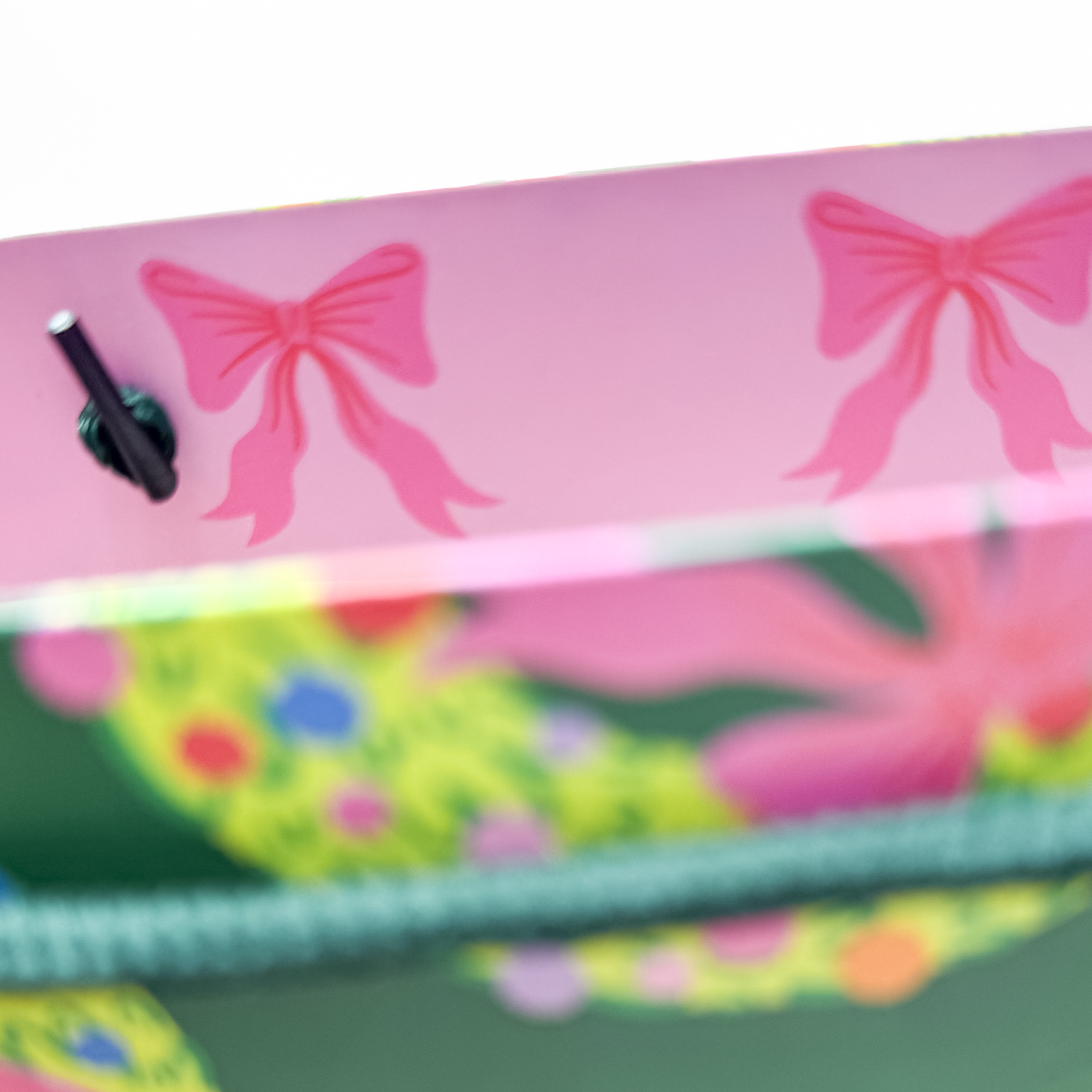 Front detail of gift bag featuring hand-illustrated rainbow wreath artwork