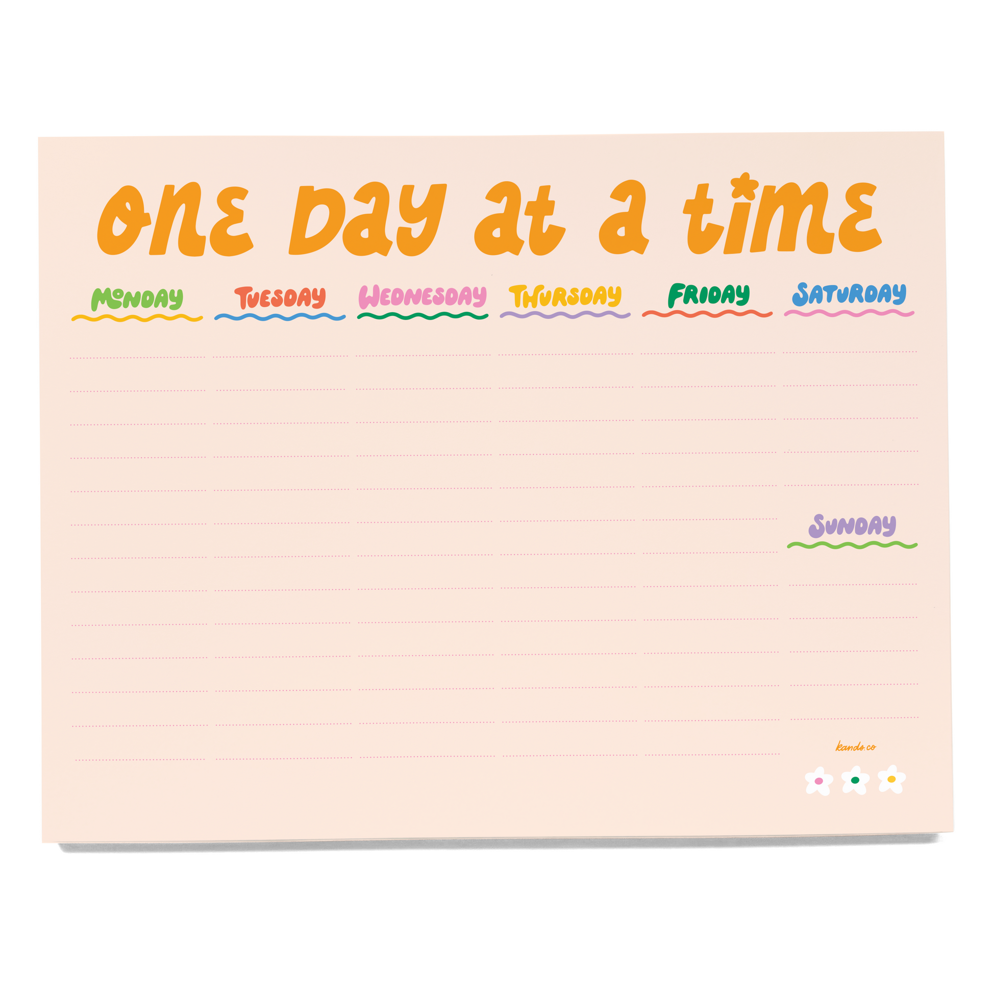 Notepad with 'One Day at a Time' days of the week layout on a light pink background