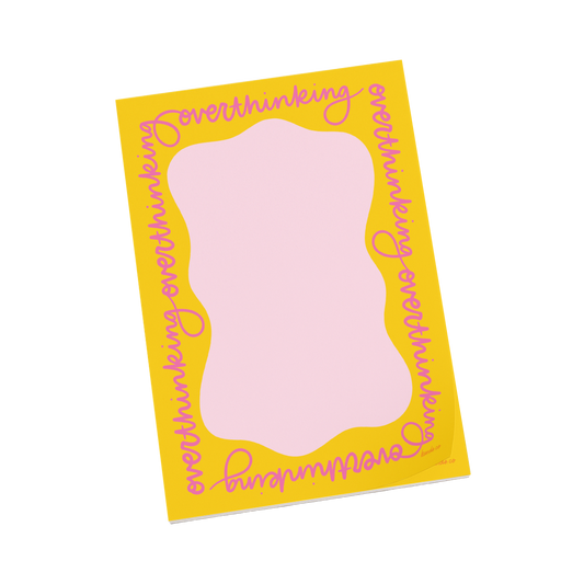 Notebook with pink interior and yellow border with overthinking written around the edges